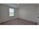 Neutral bedroom featuring a window with blinds and neutral walls at 1429 Discovery St, Davenport, FL 33896