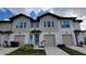 New construction townhome features neutral siding, an attached garage, and manicured landscaping at 1429 Discovery St, Davenport, FL 33896