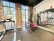 Fitness center featuring modern exercise equipment, including treadmills, against an exposed brick wall at 1429 Discovery St, Davenport, FL 33896