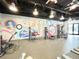 Fitness center complete with modern exercise equipment and vibrant mural accents to enhance your workout at 1429 Discovery St, Davenport, FL 33896