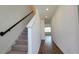 Bright hallway features recessed lighting, a staircase with modern railing, and wood-look flooring at 1429 Discovery St, Davenport, FL 33896