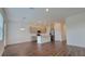 Bright kitchen offers a kitchen island with stainless appliances, pendant lighting, and gray cabinets at 1429 Discovery St, Davenport, FL 33896