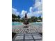 Beautiful community pool area featuring a festive Christmas tree and inviting lounge chairs for relaxing at 1429 Discovery St, Davenport, FL 33896