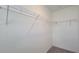 Walk-in closet with installed shelving for organized storage and carpeting at 1429 Discovery St, Davenport, FL 33896