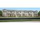 Charming row of new two-story townhomes, each boasting unique architectural details and manicured lawns at 1828 Crowncrest Dr, Apopka, FL 32703