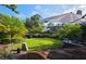 Charming backyard featuring a lush lawn, brick patio, and mature trees, ideal for relaxation at 208 Frinton Cv, Longwood, FL 32779