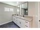 Modern bathroom featuring double sinks, granite countertops, and two large mirrors at 208 Frinton Cv, Longwood, FL 32779