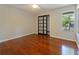 Bedroom featuring hardwood floors, a closet with sliding glass doors and large windows at 208 Frinton Cv, Longwood, FL 32779