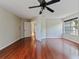 Bedroom boasts hardwood floors, neutral walls, and a window overlooking trees at 208 Frinton Cv, Longwood, FL 32779