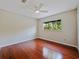 Bedroom with cherry-wood floors, neutral walls, and light from the single window at 208 Frinton Cv, Longwood, FL 32779