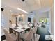 Staged dining room with seating for six, an open floorplan, hardwood floors, and a calming view of the outdoors at 208 Frinton Cv, Longwood, FL 32779