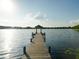 Picture-perfect view of a private dock on a tranquil lake, offering serene waterfront living at 208 Frinton Cv, Longwood, FL 32779