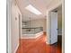 Upstairs hallway featuring hardwood floors, a skylight, and views of other rooms at 208 Frinton Cv, Longwood, FL 32779