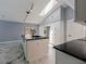 Updated kitchen boasts stainless steel appliances, modern countertops, custom cabinets, and marble tile flooring at 208 Frinton Cv, Longwood, FL 32779