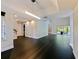 Bright open-concept living room with black hardwood floors, recessed lighting, and neutral paint colors throughout at 208 Frinton Cv, Longwood, FL 32779