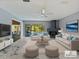 Staged living room featuring stylish furniture, a decorative fireplace, a ceiling fan, and an outdoor view at 208 Frinton Cv, Longwood, FL 32779