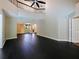 Spacious living room with black hardwood floors, high ceilings, and view into other parts of the open floorplan at 208 Frinton Cv, Longwood, FL 32779