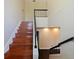 Beautiful wooden staircase with black railing leading to the second floor at 208 Frinton Cv, Longwood, FL 32779