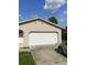 Side view of a home showcasing the garage and driveway. Lawn needs some work at 2087 Allegheny Ct, Orlando, FL 32818