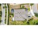 Overhead shot of roof and back yard with brick driveway, and landscaping with mature trees at 2108 Antilles Club Dr, Kissimmee, FL 34747