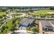 Aerial view of a home nestled in a landscaped neighborhood near a golf course with mature trees at 2108 Antilles Club Dr, Kissimmee, FL 34747