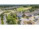 Aerial view of a residential neighborhood featuring lush landscaping, a golf course, and a roundabout at 2108 Antilles Club Dr, Kissimmee, FL 34747