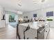 Modern kitchen features a large island with waterfall countertop and an open view of the living area at 2108 Antilles Club Dr, Kissimmee, FL 34747