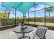 Screened-in lanai with a table and chairs with green space views at 2108 Antilles Club Dr, Kissimmee, FL 34747