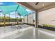 Screened-in lanai with a table and chairs and roll down blinds for shade at 2108 Antilles Club Dr, Kissimmee, FL 34747