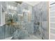 Luxurious shower featuring unique patterned blue tile and gold fixtures at 2108 Antilles Club Dr, Kissimmee, FL 34747