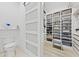Bathroom doorway view of a well-organized walk-in closet with custom shelving at 2108 Antilles Club Dr, Kissimmee, FL 34747