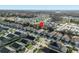 Wide aerial view showcasing neighborhood layout with well-maintained homes and beautiful green spaces at 2115 Morning Star Drive, Clermont, FL 34714