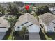 Aerial view of a single-story home with neutral paint, a two-car garage, and mature landscaping at 2115 Morning Star Drive, Clermont, FL 34714