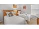 Cozy bedroom featuring two beds, carpeted floor and bright natural light at 2115 Morning Star Drive, Clermont, FL 34714