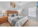 Bright bedroom featuring a ceiling fan, natural light, and a queen-size bed with luxury linens at 2115 Morning Star Drive, Clermont, FL 34714