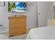 Cozy bedroom featuring a wood dresser, flat screen television, and plush carpeting at 2115 Morning Star Drive, Clermont, FL 34714