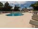 Well-maintained community pool area with lounge chairs and scenic surroundings offers resort-style living at 2115 Morning Star Drive, Clermont, FL 34714