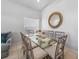 Dining area featuring neutral paint, tile floors, a contemporary table and chair set, and decorative mirror at 2115 Morning Star Drive, Clermont, FL 34714