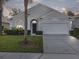 Charming single-story home with a well-maintained lawn, mature landscaping, and a two-car garage at 2115 Morning Star Drive, Clermont, FL 34714