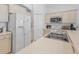 Functional kitchen with ample storage, neutral cabinets, a tile backsplash, and modern appliances at 2115 Morning Star Drive, Clermont, FL 34714