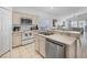 Bright kitchen featuring white appliances, light cabinets, and a breakfast bar open to the living area at 2115 Morning Star Drive, Clermont, FL 34714