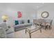 Open concept living room with neutral paint, tile floors, and stylish decor at 2115 Morning Star Drive, Clermont, FL 34714