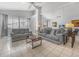 Spacious living room with neutral colors, tiled floors, ceiling fan, and large windows at 2115 Morning Star Drive, Clermont, FL 34714