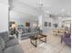Open-concept living room with mirrored wall, tiled floors, and ample seating at 2115 Morning Star Drive, Clermont, FL 34714