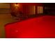 Backyard pool with lounge seating and vibrant red lighting at 2115 Morning Star Drive, Clermont, FL 34714