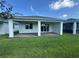 Spacious covered patio with a brick paver floor and a lush green lawn, perfect for outdoor entertaining at 2333 Daisy Tree Rd, St Cloud, FL 34771