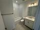 Bright bathroom featuring a shower and tub combination and a single sink vanity at 2333 Daisy Tree Rd, St Cloud, FL 34771