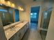 Bathroom with a double sink vanity, tile flooring, and glass-enclosed walk-in shower at 2333 Daisy Tree Rd, St Cloud, FL 34771