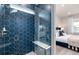 Stunning primary bathroom with blue tile shower and glass door entry into bedroom at 2333 Daisy Tree Rd, St Cloud, FL 34771