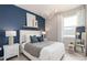 Bright bedroom featuring a blue accent wall, white trim, and modern light fixture at 2333 Daisy Tree Rd, St Cloud, FL 34771
